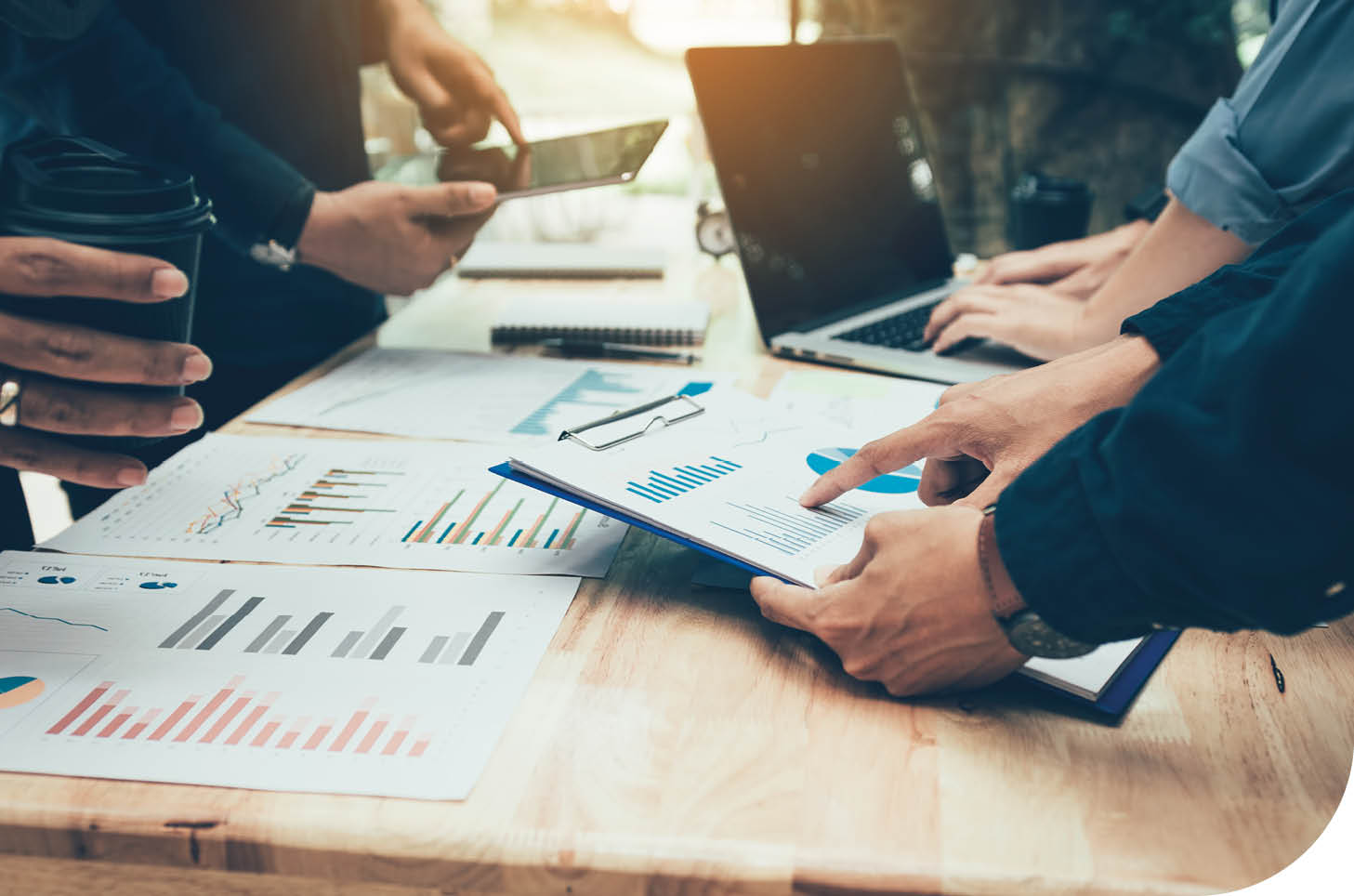 Teamwork with business people analysis cost graph on desk at meeting room.
