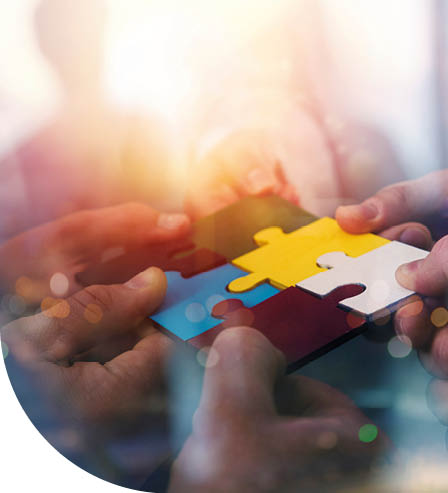 Business people join puzzle pieces in office. Concept of teamwork and partnership. double exposure with light effects